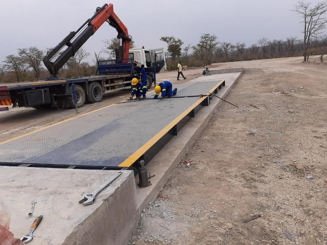Premier Scales crew installing a weighbridge deck, with the crane truck on site